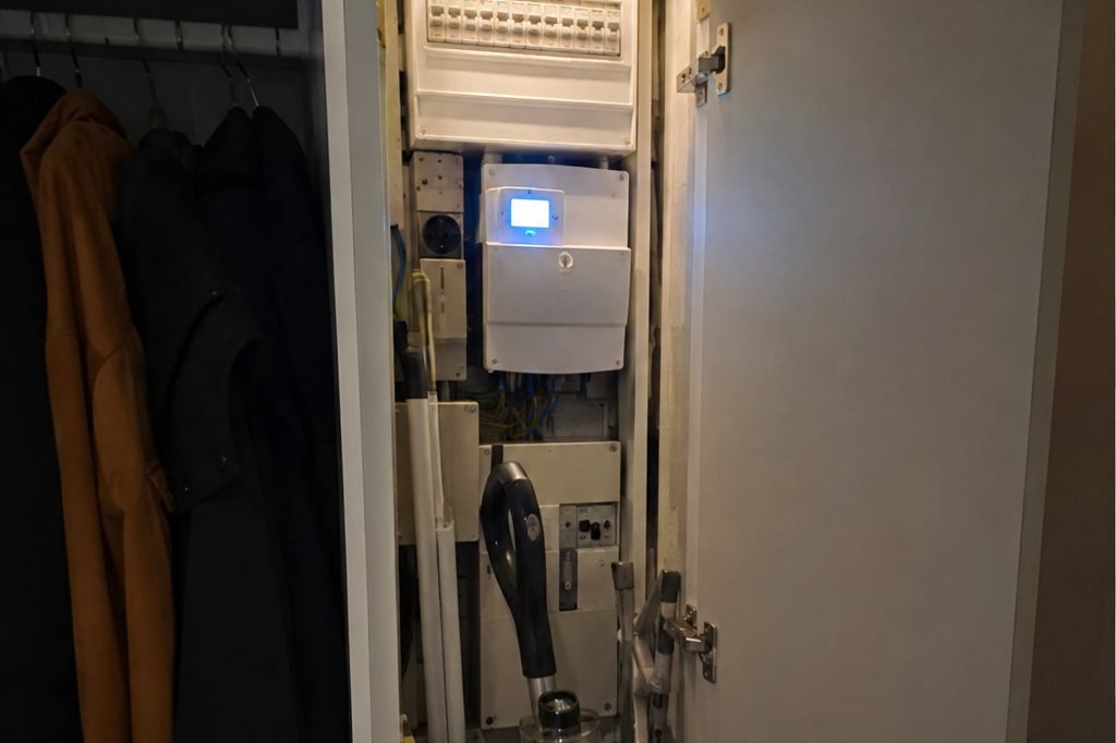 A fuse box and meter in a hallway cupboard