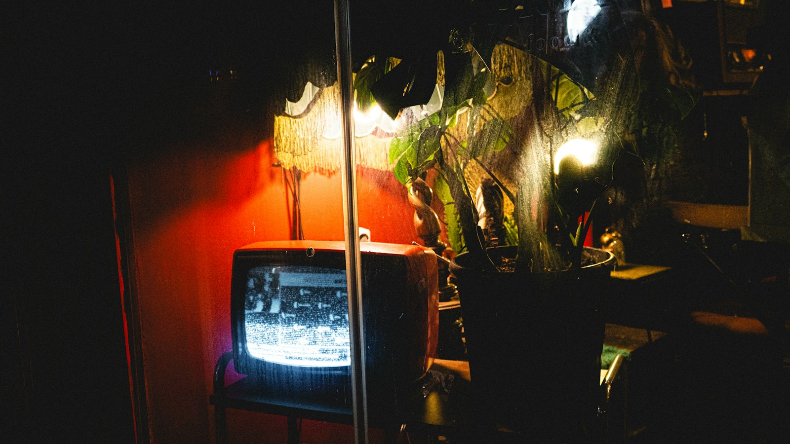 An old television glowing in a dark living room